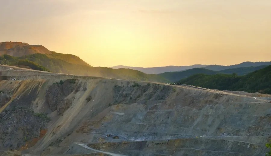 Open-pit mine terraces in golden hour light