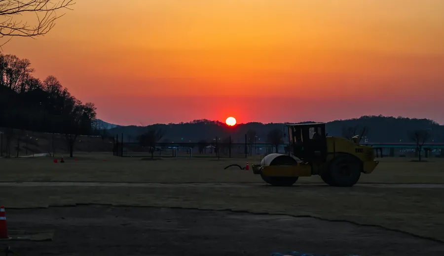 Steamroller silhouette at sunset