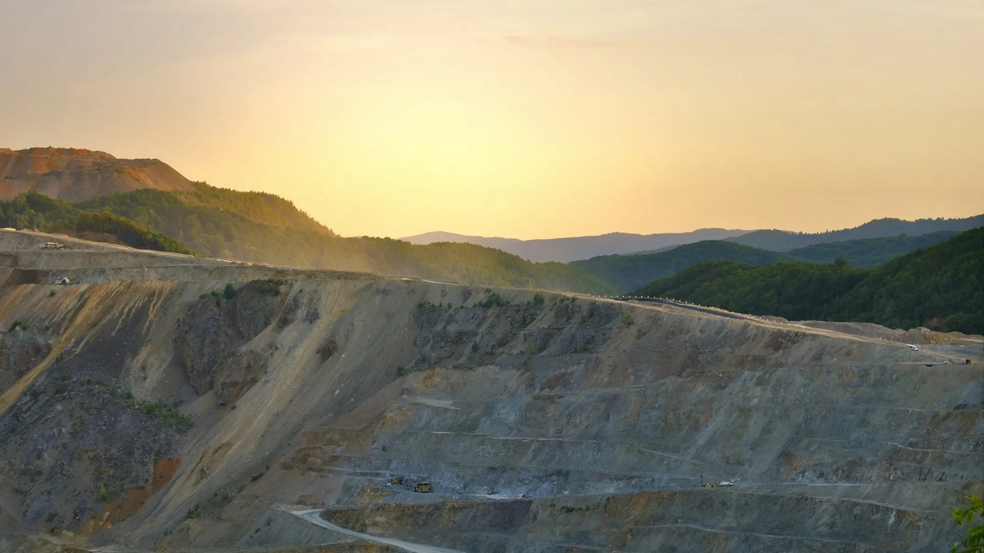 Terraced open-pit mine at golden hour